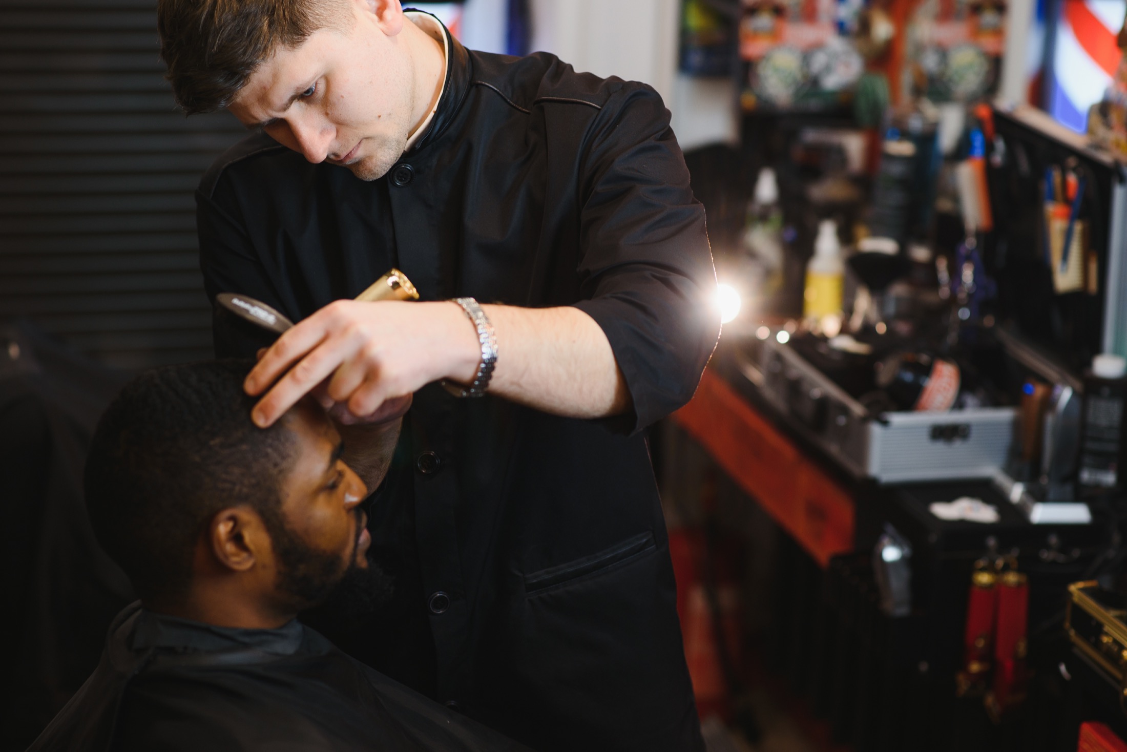 Focused barber trimming a client
